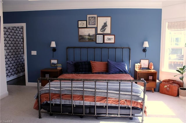 carpeted bedroom with crown molding and baseboards