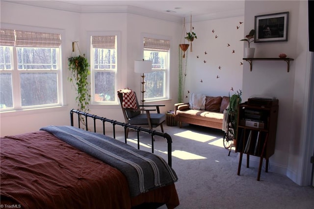 carpeted bedroom featuring crown molding