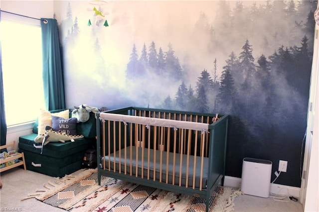 bedroom featuring carpet floors, a crib, and baseboards