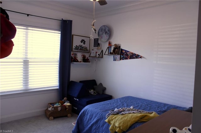 carpeted bedroom with ornamental molding, multiple windows, and baseboards