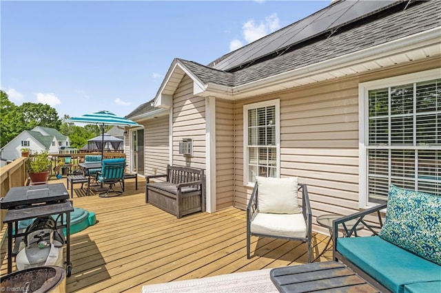 wooden terrace featuring outdoor dining area