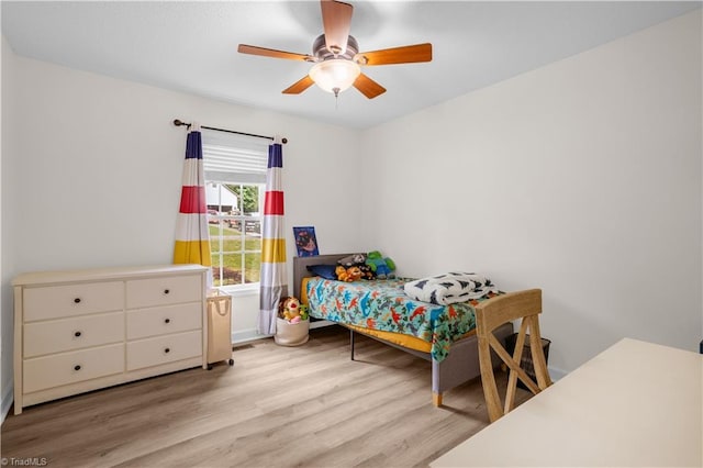 bedroom featuring a ceiling fan and wood finished floors