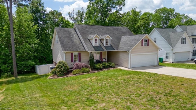 new england style home featuring a garage, a front lawn, fence, and concrete driveway