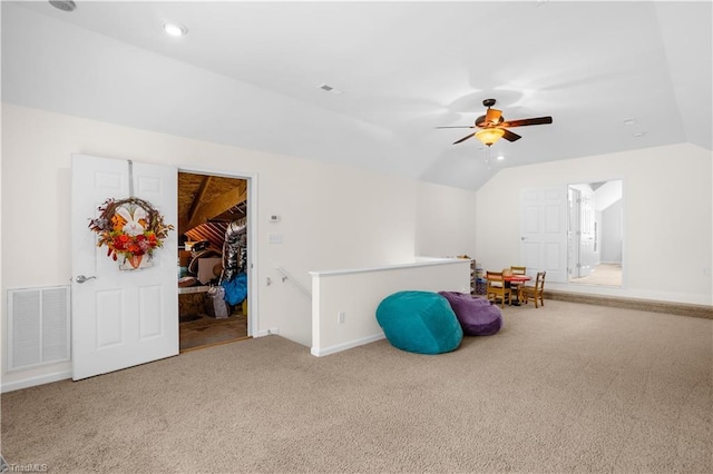 playroom with ceiling fan, carpet floors, baseboards, vaulted ceiling, and visible vents