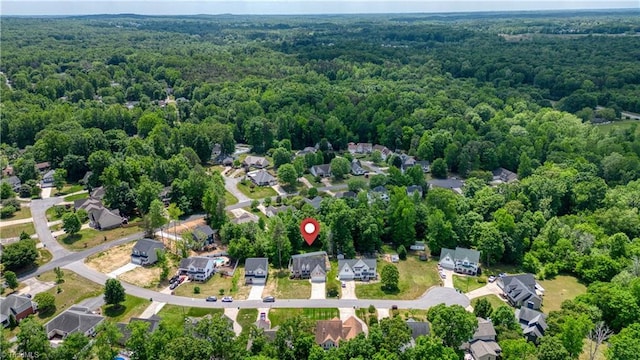 birds eye view of property featuring a view of trees and a residential view