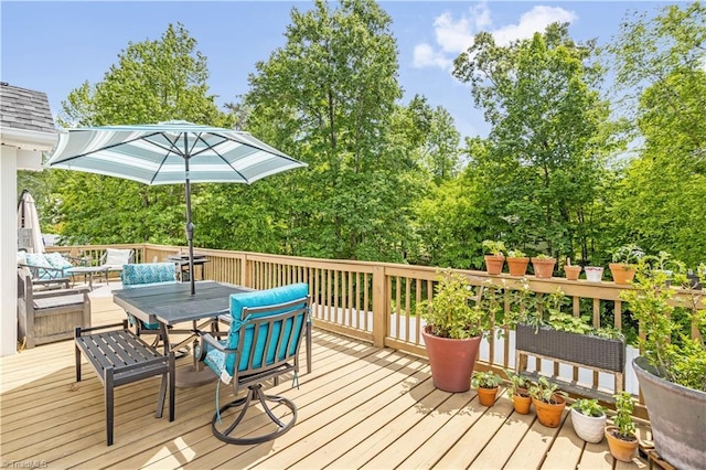 wooden terrace featuring outdoor dining area