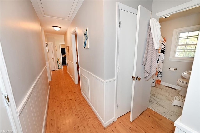 hallway with light hardwood / wood-style flooring