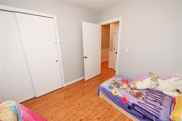 bedroom featuring light hardwood / wood-style flooring and a closet