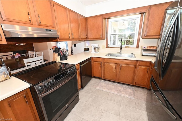 kitchen with decorative backsplash, black appliances, and sink