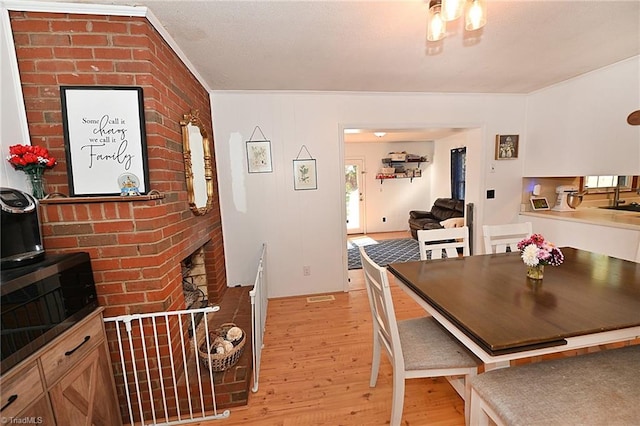 dining area featuring sink and light wood-type flooring