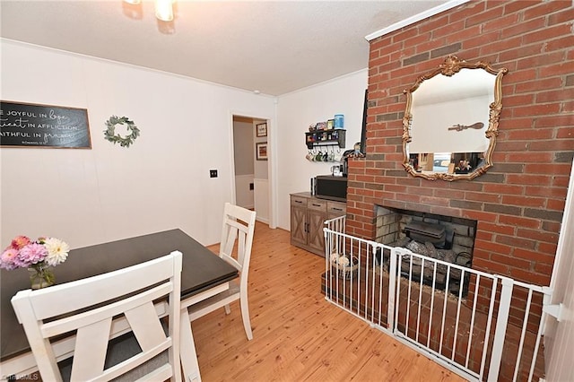 dining area featuring wood-type flooring and a fireplace