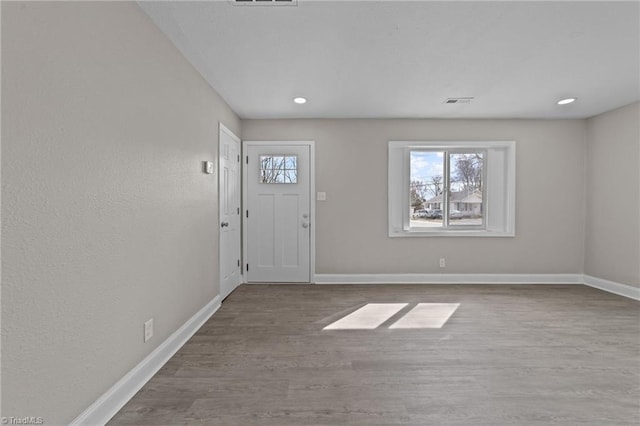 entryway featuring recessed lighting, wood finished floors, visible vents, and baseboards