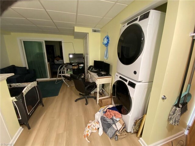 301 Jeanette Ave, High Point, NC 27265 - clothes washing area featuring laundry area, visible vents, stacked washer and clothes dryer, and light wood-style floors