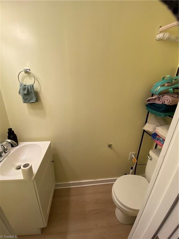301 Jeanette Ave, High Point, NC 27265 - bathroom featuring baseboards, vanity, toilet, and wood finished floors