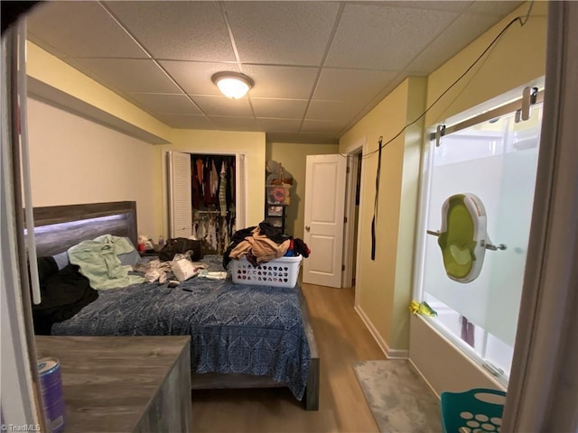 301 Jeanette Ave, High Point, NC 27265 - bedroom featuring wood finished floors, baseboards, a drop ceiling, and a closet