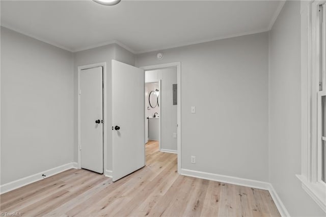 unfurnished bedroom featuring light hardwood / wood-style floors and crown molding