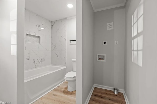 bathroom featuring toilet, shower / bathtub combination, crown molding, and hardwood / wood-style floors