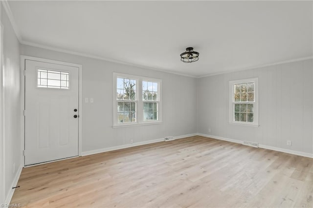 entrance foyer with light hardwood / wood-style floors and crown molding