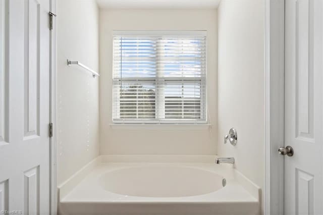 bathroom featuring a tub to relax in