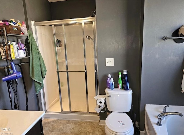 full bathroom featuring vanity, tile patterned floors, toilet, and separate shower and tub