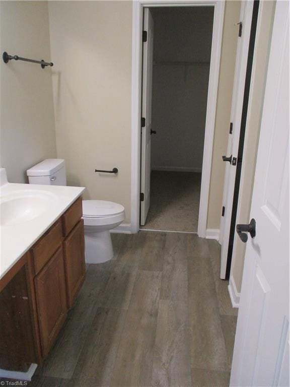 917 Avalon Acres Ct, High Point, NC 27265 - bathroom with toilet, vanity, wood finished floors, and baseboards