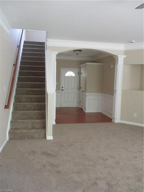 917 Avalon Acres Ct, High Point, NC 27265 - interior space featuring carpet floors, ornate columns, arched walkways, crown molding, and a decorative wall