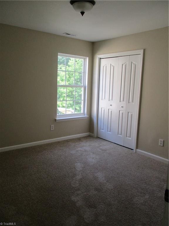 917 Avalon Acres Ct, High Point, NC 27265 - unfurnished bedroom featuring carpet floors, baseboards, and a closet