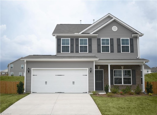 view of front of house featuring a front lawn and a garage