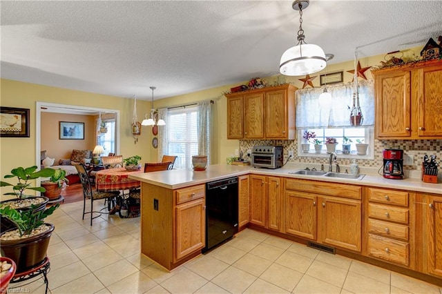 kitchen featuring dishwasher, sink, hanging light fixtures, tasteful backsplash, and kitchen peninsula