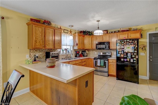 kitchen featuring kitchen peninsula, sink, hanging light fixtures, and black appliances