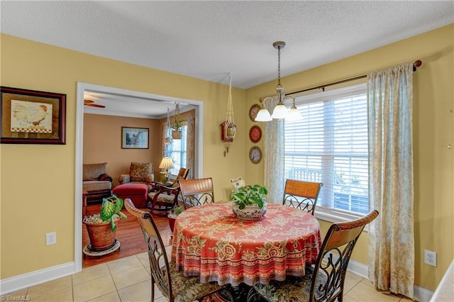 dining space featuring a textured ceiling, light hardwood / wood-style flooring, and a wealth of natural light