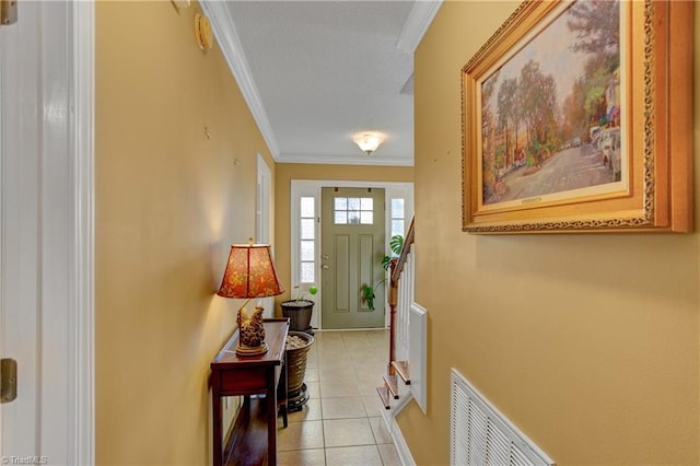 doorway with crown molding and light tile patterned flooring