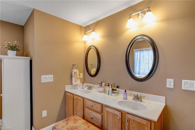 bathroom with vanity and a textured ceiling