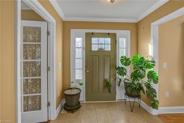 tiled entrance foyer with crown molding and a textured ceiling