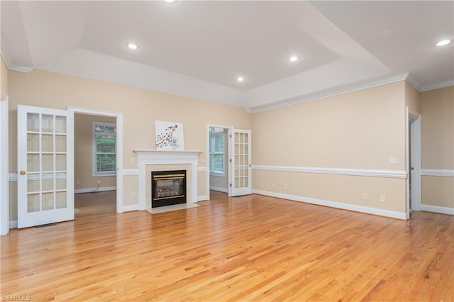 2012 Muirfield Ct, Elon, NC 27244 - unfurnished living room with a tray ceiling, light wood-style flooring, recessed lighting, ornamental molding, and baseboards