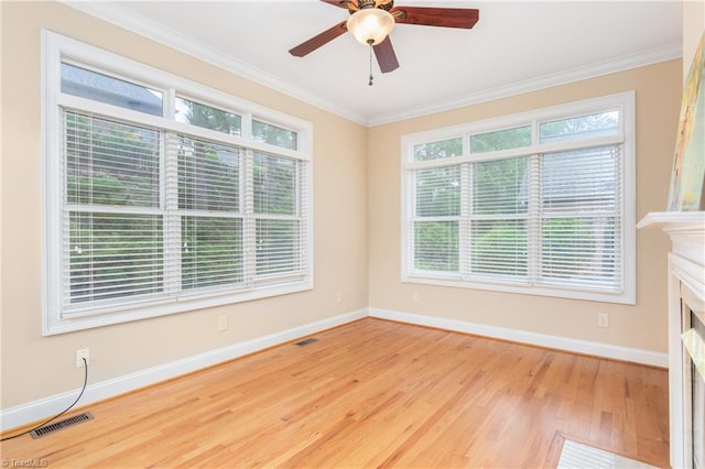 2012 Muirfield Ct, Elon, NC 27244 - spare room featuring wood finished floors, baseboards, crown molding, ceiling fan, and a fireplace
