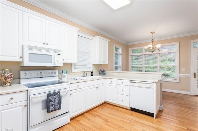 2012 Muirfield Ct, Elon, NC 27244 - kitchen featuring white appliances, healthy amount of natural light, a chandelier, ornamental molding, and light countertops