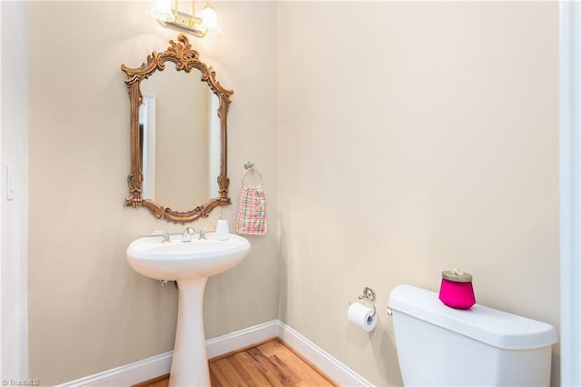 2012 Muirfield Ct, Elon, NC 27244 - bathroom featuring toilet, baseboards, and wood finished floors