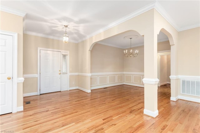 2012 Muirfield Ct, Elon, NC 27244 - entryway with arched walkways, a chandelier, light wood-style flooring, and crown molding