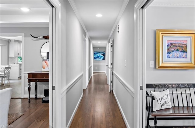 hallway with dark wood-style floors, ornamental molding, and recessed lighting
