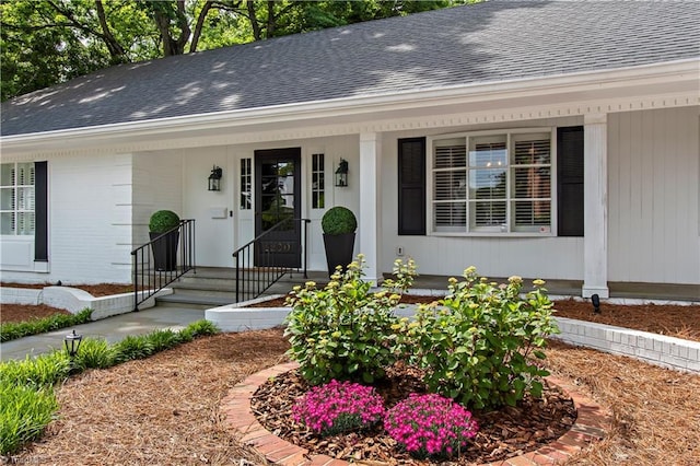view of front of home with a shingled roof and covered porch