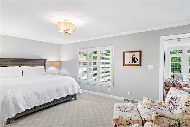 bedroom with baseboards, ornamental molding, and carpet floors