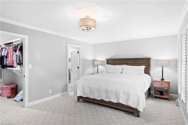 bedroom featuring light colored carpet, ornamental molding, baseboards, a spacious closet, and a closet