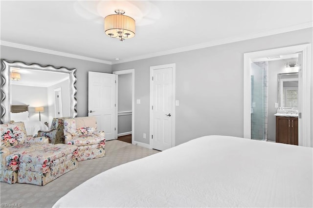 bedroom with ornamental molding, baseboards, ensuite bathroom, and carpet