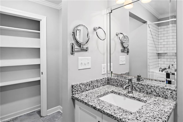 full bathroom with crown molding, vanity, baseboards, and shower / bath combination