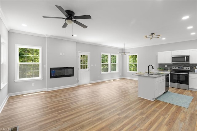 411 Motif Ln, Winston-Salem, NC 27107 - kitchen with stainless steel appliances, ornamental molding, plenty of natural light, open floor plan, and a chandelier