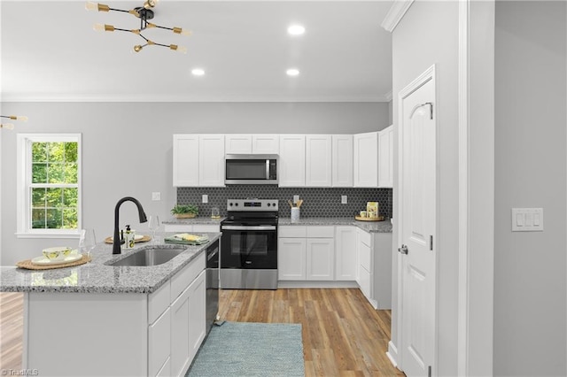 411 Motif Ln, Winston-Salem, NC 27107 - kitchen featuring stainless steel appliances, crown molding, a chandelier, white cabinets, and light wood-type flooring