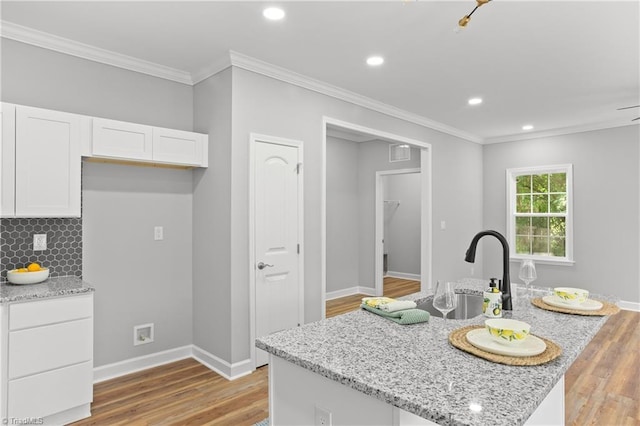 411 Motif Ln, Winston-Salem, NC 27107 - kitchen featuring white cabinetry, light stone countertops, backsplash, ornamental molding, and recessed lighting