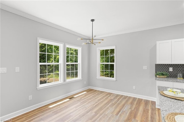 411 Motif Ln, Winston-Salem, NC 27107 - unfurnished dining area featuring a chandelier, ornamental molding, and light wood-style flooring