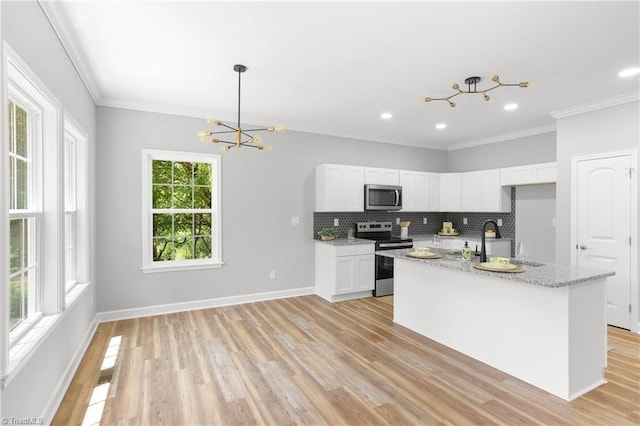 411 Motif Ln, Winston-Salem, NC 27107 - kitchen featuring stainless steel appliances, light wood-style floors, white cabinetry, crown molding, and light stone countertops